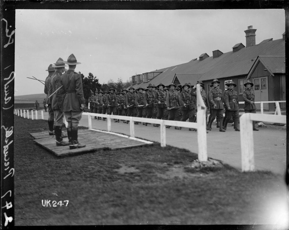 Men of the Auckland Battalion performing the 'Piccadilly' or regular march past officers at Sling Camp, England. 